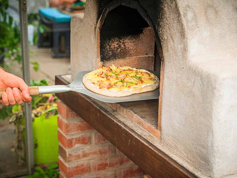 Outdoor kitchen with pizza oven in the South Lakes