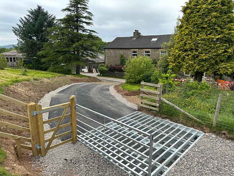 JCustom stone path with cattlegrid and landscaping