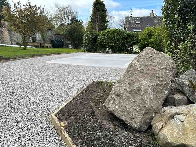 landscaped garden with stone driveway